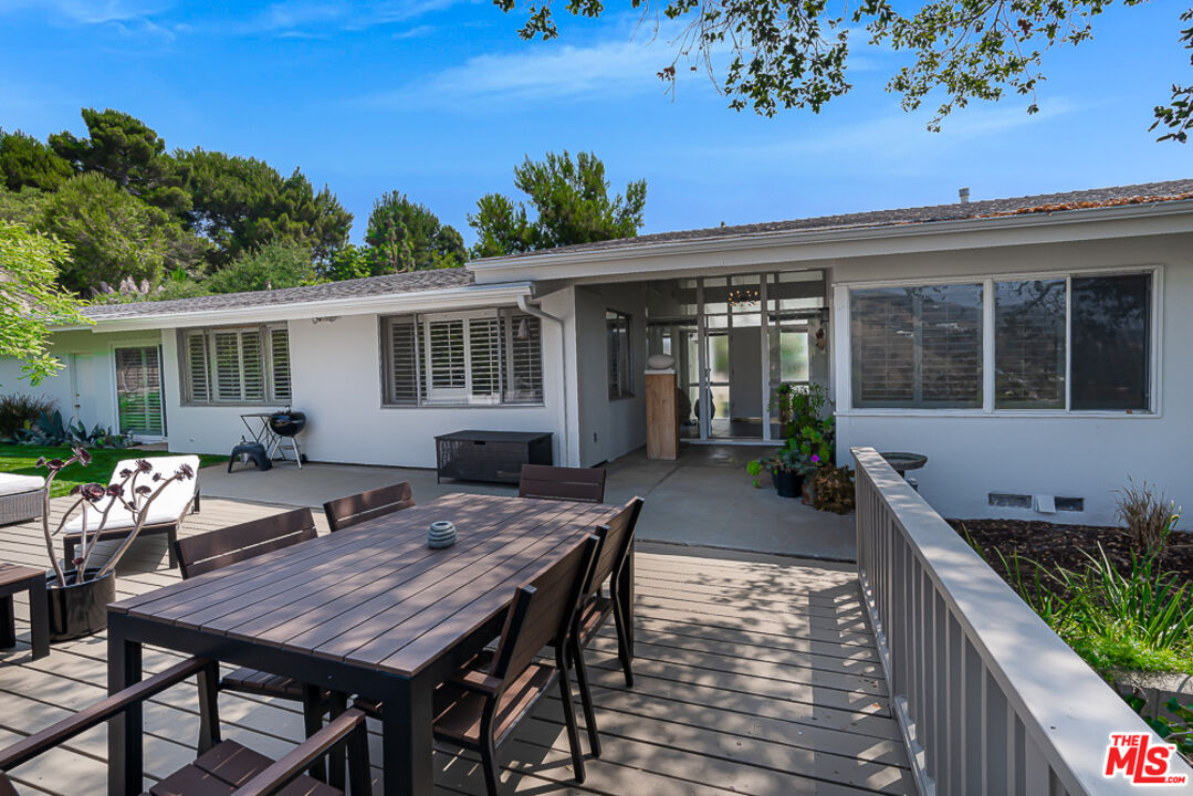 1373 Las Canoas Road Pacific Palisades, CA 90272 - Photo 17 of 19 a view of a dinning table and chairs in patio of the house