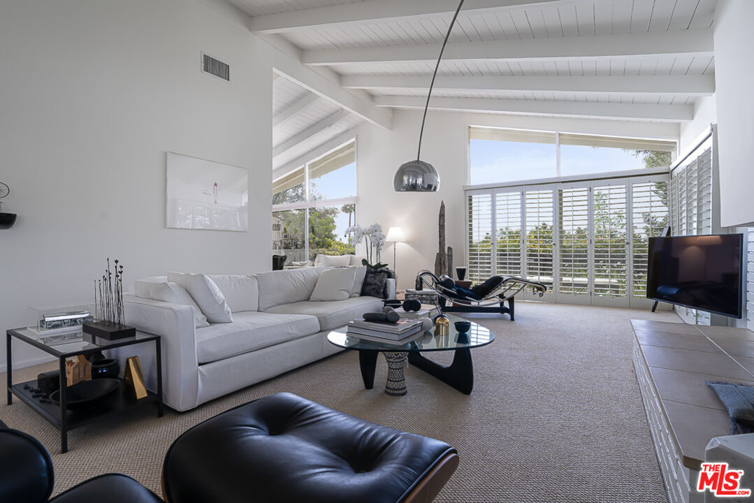 1373 Las Canoas Road Pacific Palisades, CA 90272 - Photo 6 of 19 a living room with furniture and a flat screen tv