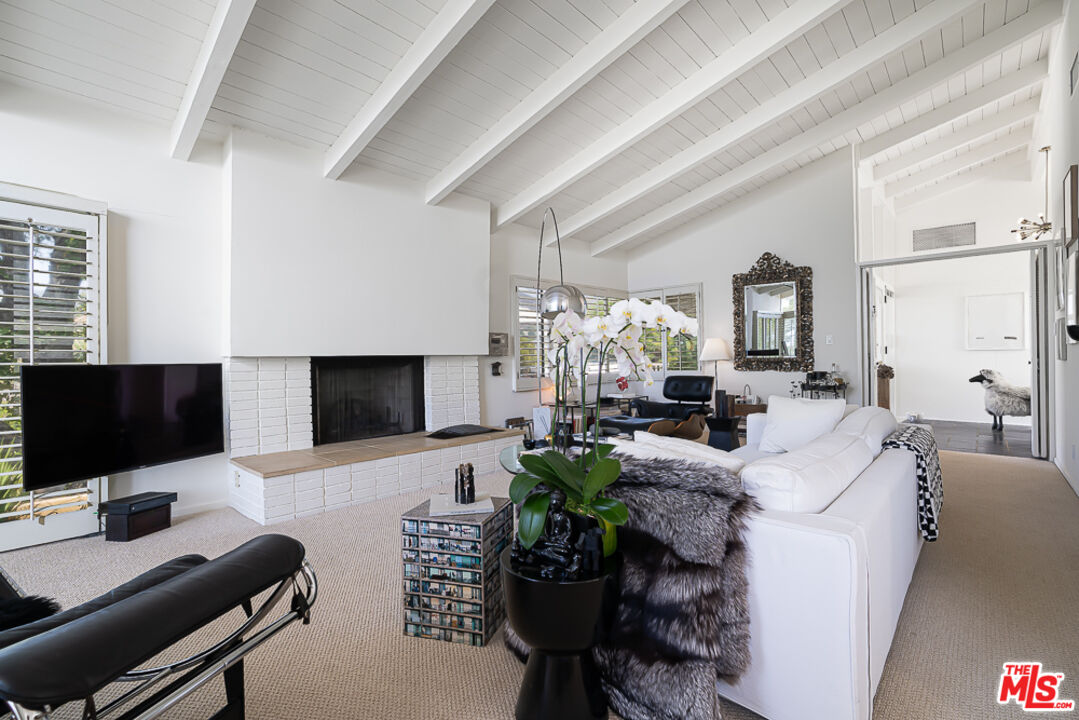 1373 Las Canoas Road Pacific Palisades, CA 90272 - Photo 7 of 19 a living room with furniture and a flat screen tv