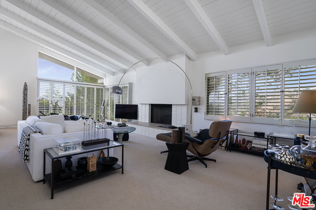 1373 Las Canoas Road Pacific Palisades, CA 90272 - Photo 8 of 19 a living room with furniture and a large window
