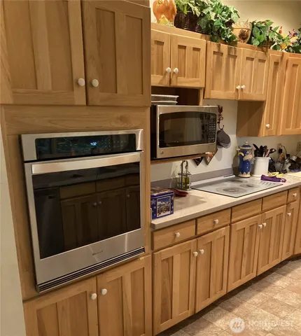 a kitchen with granite countertop a stove microwave and sink
