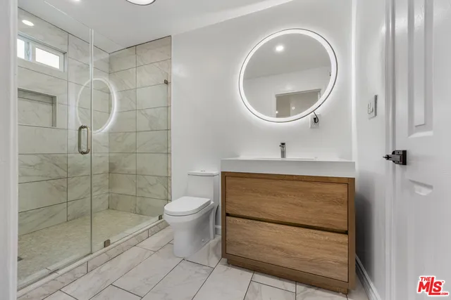 a bathroom with a toilet a sink and shower