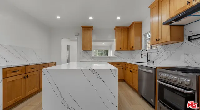 a kitchen with a sink stove and refrigerator