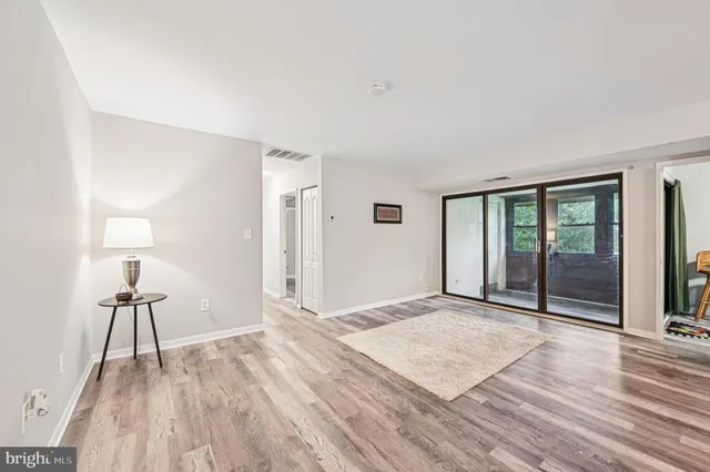 a view of a room with wooden floor and lamp