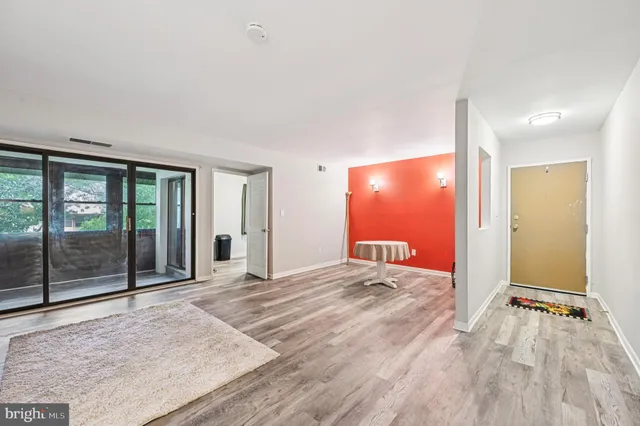 a view of a room with wooden floor and window