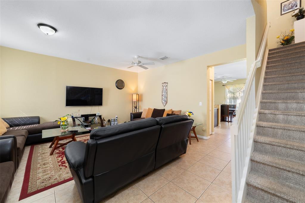 8915 Southwest 19th Street, Unit 8915 Miramar, FL 33025 - Photo 11 of 27 a living room with furniture and a flat screen tv