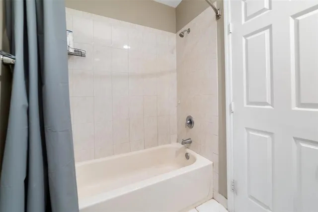 a bathroom with a bathtub and shower
