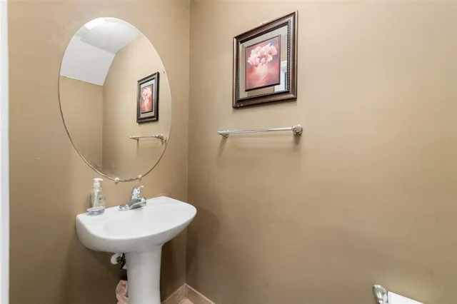 a bathroom with a sink mirror and toilet