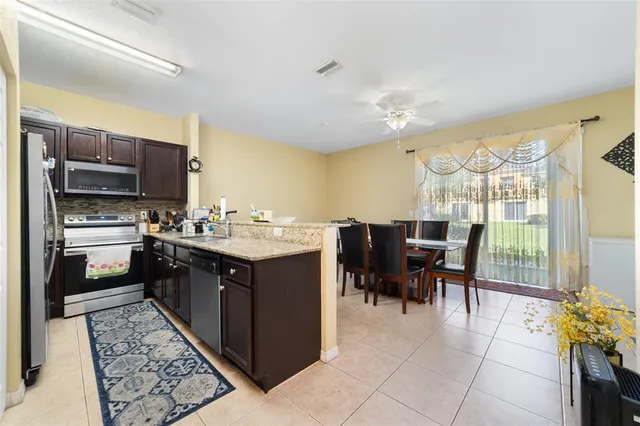 a kitchen with a sink refrigerator and cabinets