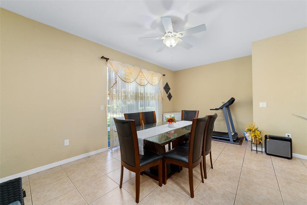 8915 Southwest 19th Street, Unit 8915 Miramar, FL 33025 - Photo 10 of 27 a view of a dining room with furniture and chandelier