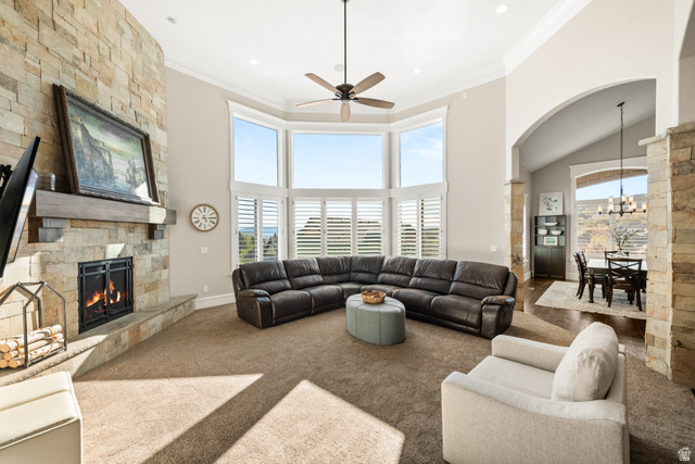 1205 North Elk Rdg Lane, Unit 202 Alpine, UT 84004 - Photo 14 of 88 Spacious living area featuring a stone-clad fireplace with wood mantle, large bay windows with plantation shutters, vaulted ceilings, and recessed lighting