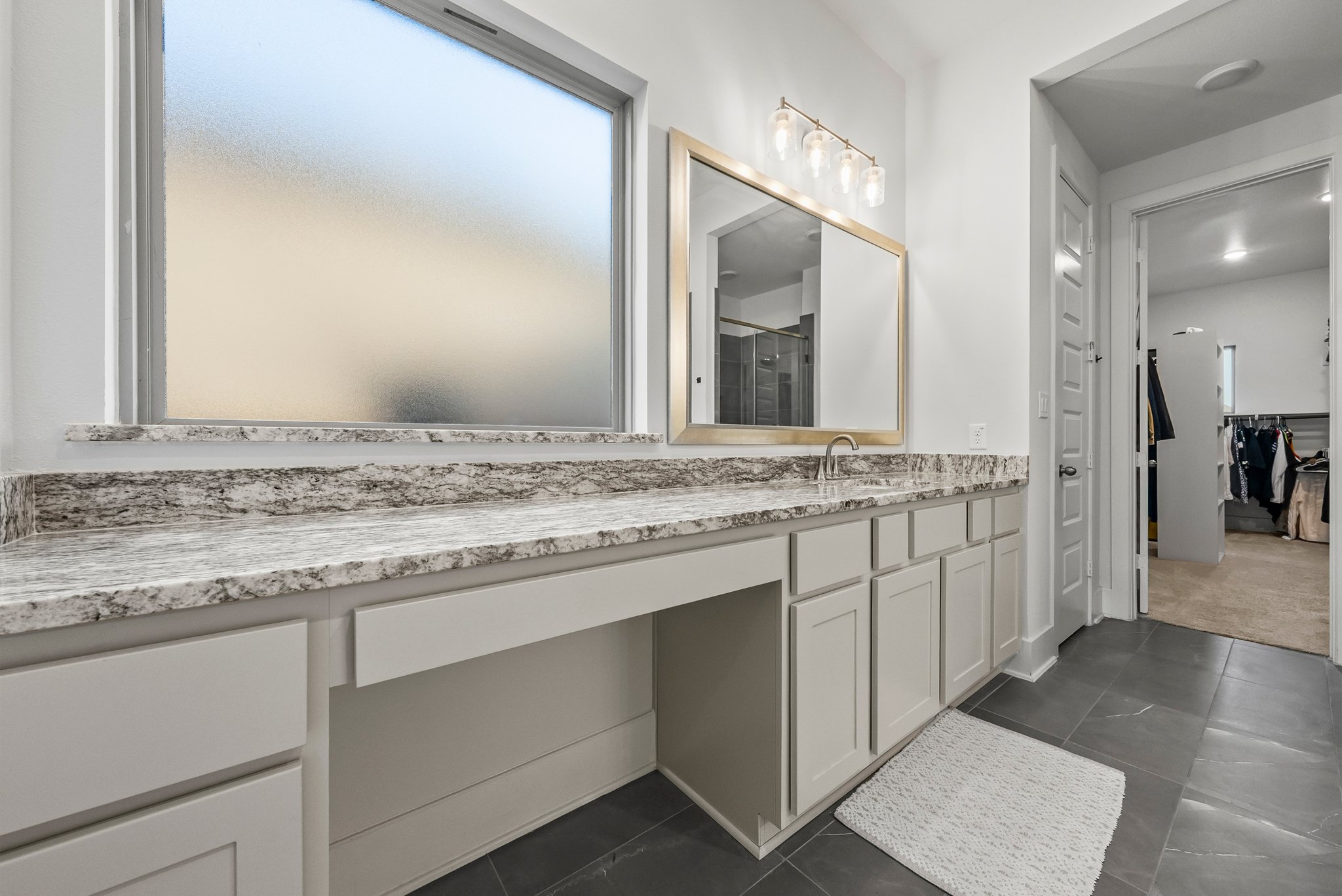 124 Low River Lane Georgetown, TX 78628 - Photo 17 of 38 a bathroom with a granite countertop sink and a mirror