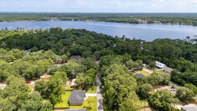 an aerial view of a houses with a lake view