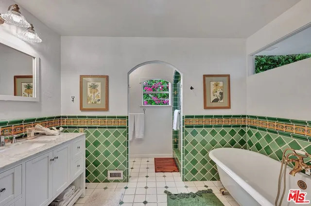 a bathroom with a sink mirror and a bathtub