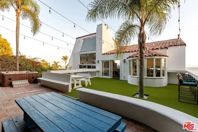a view of a house with swimming pool and sitting area