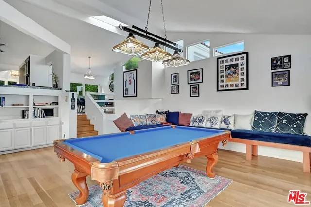 a kitchen with stainless steel appliances granite countertop a stove a sink and a wooden floors