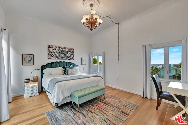 a bedroom with a bed a table and chair