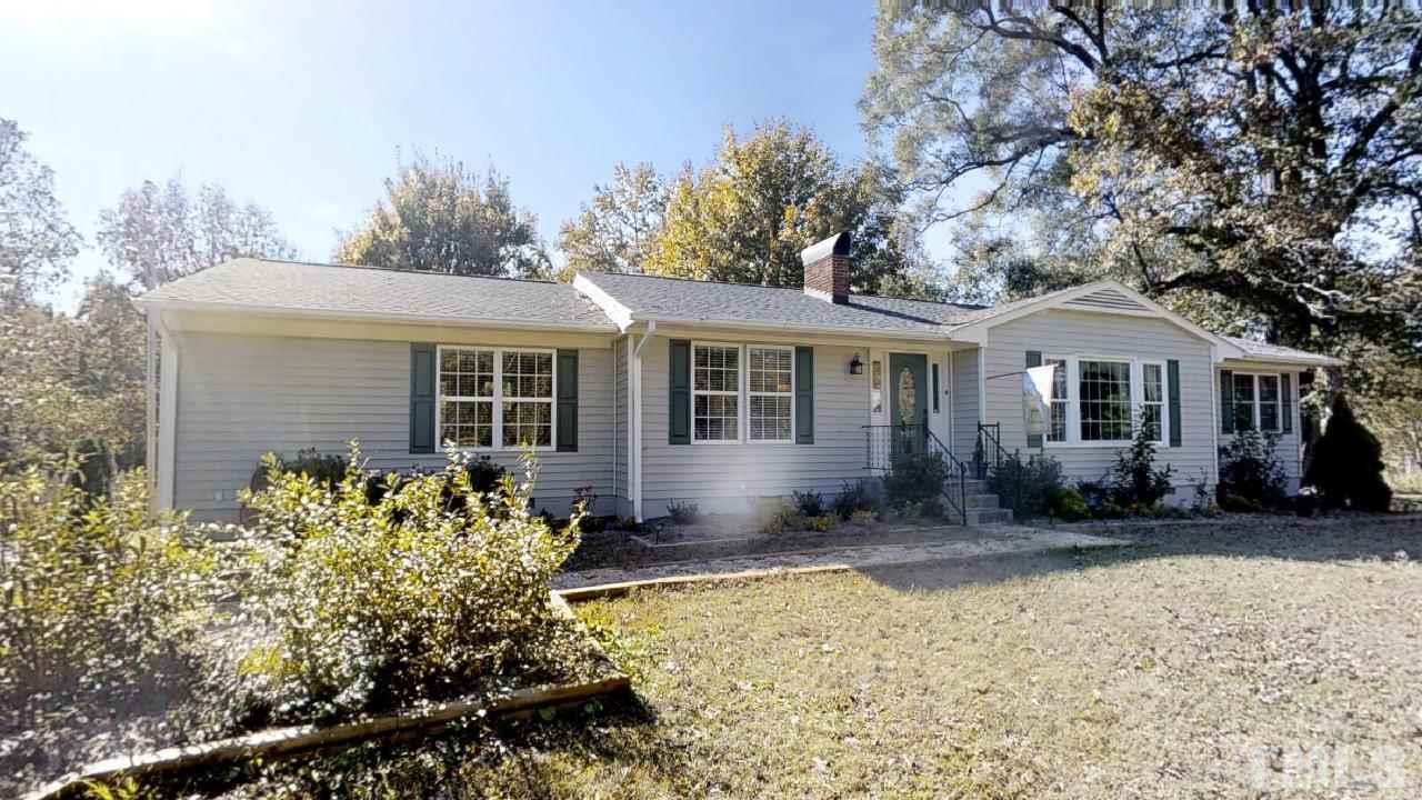 10027 Rougemont Road Bahama, NC 27503 - Photo 1 of 25 front view of a house with a yard