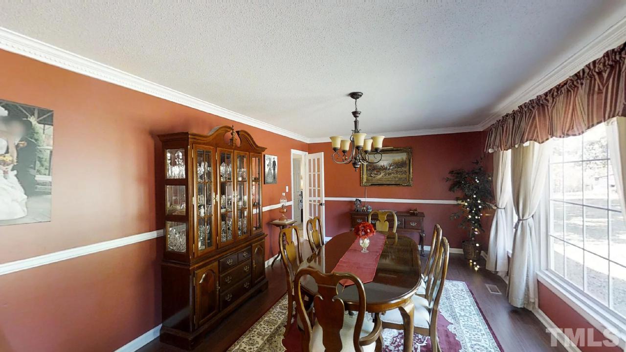 10027 Rougemont Road Bahama, NC 27503 - Photo 4 of 25 a view of a chairs and table in a balcony