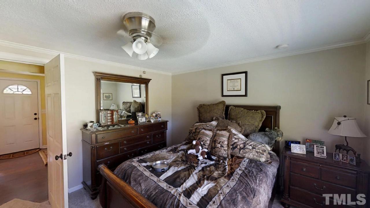 10027 Rougemont Road Bahama, NC 27503 - Photo 5 of 25 a bed room with bed and furniture