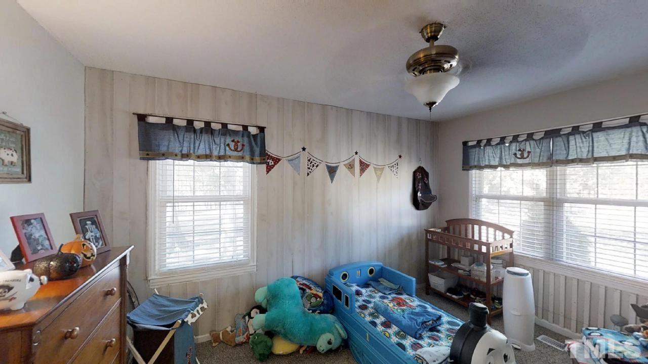 10027 Rougemont Road Bahama, NC 27503 - Photo 7 of 25 a bedroom with furniture and a window