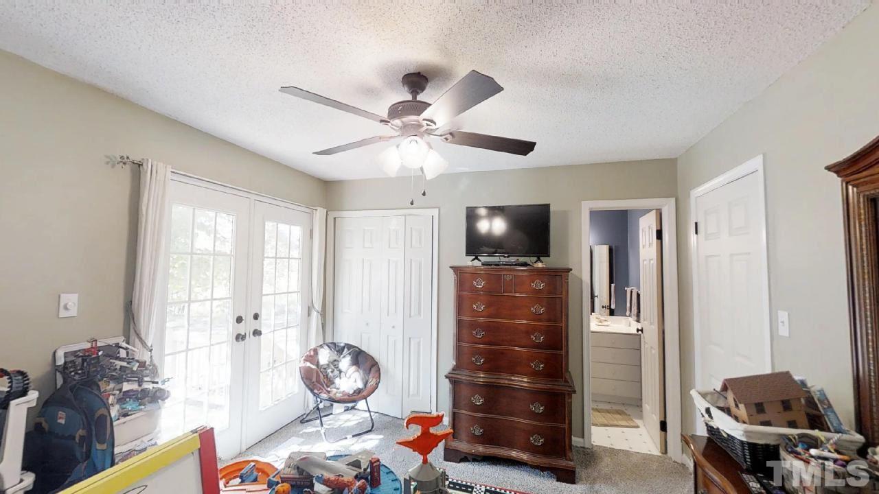 10027 Rougemont Road Bahama, NC 27503 - Photo 9 of 25 a living room with furniture and a flat screen tv