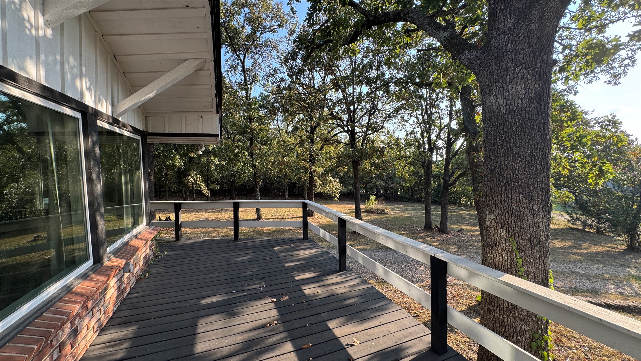 96358 South 4531 Road Vian, OK 74962 - Photo 38 of 58 Expansive outdoor deck with composite decking, white railing, floor-to-ceiling windows, and white vertical siding