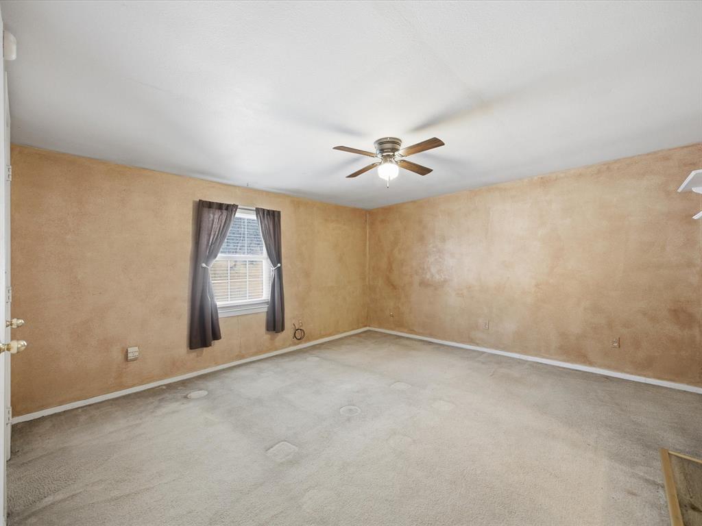 196 Perch Road Bowie, TX 76230 - Photo 23 of 33 an empty room with windows and fan