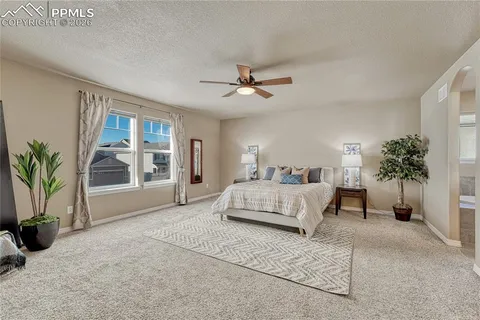 a spacious bathroom with a tub sink and a mirror