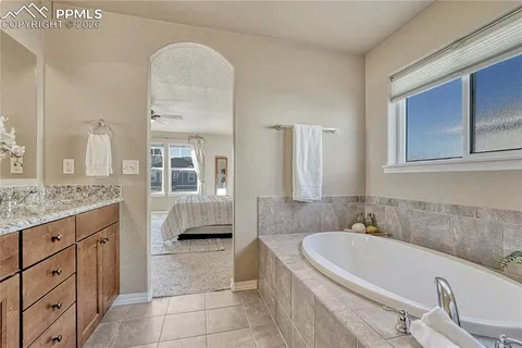 a white bath tub sitting next to a white toilet