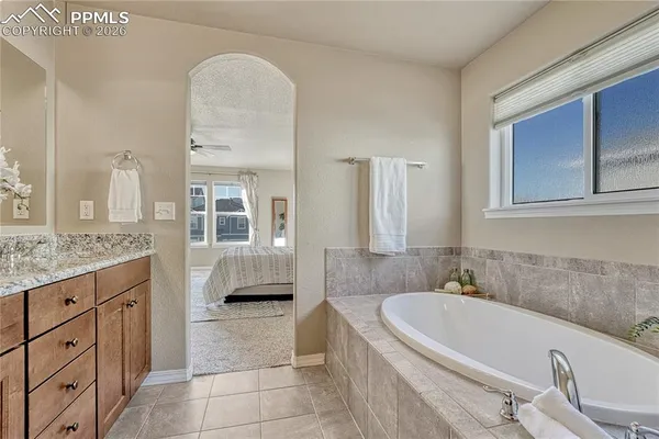 a white bath tub sitting next to a white toilet