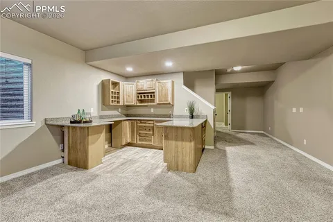 an empty room with a cabinet and mirrors