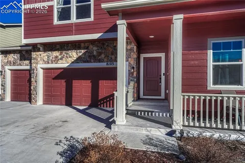 a view of a brick house with large windows