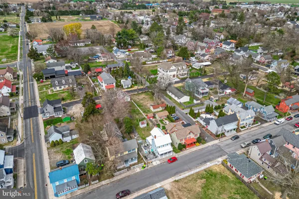 an aerial view of residential houses with outdoor space and swimming pool