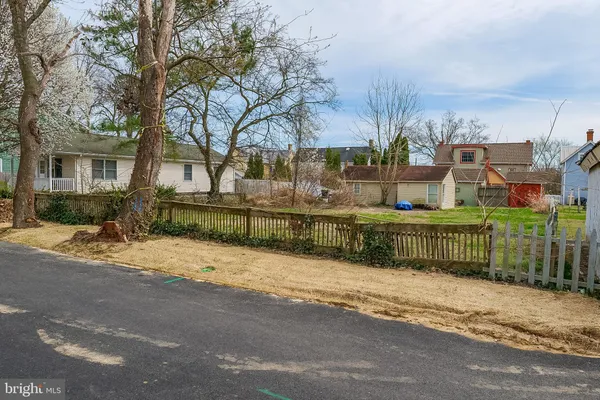 a front view of a house having yard and tree