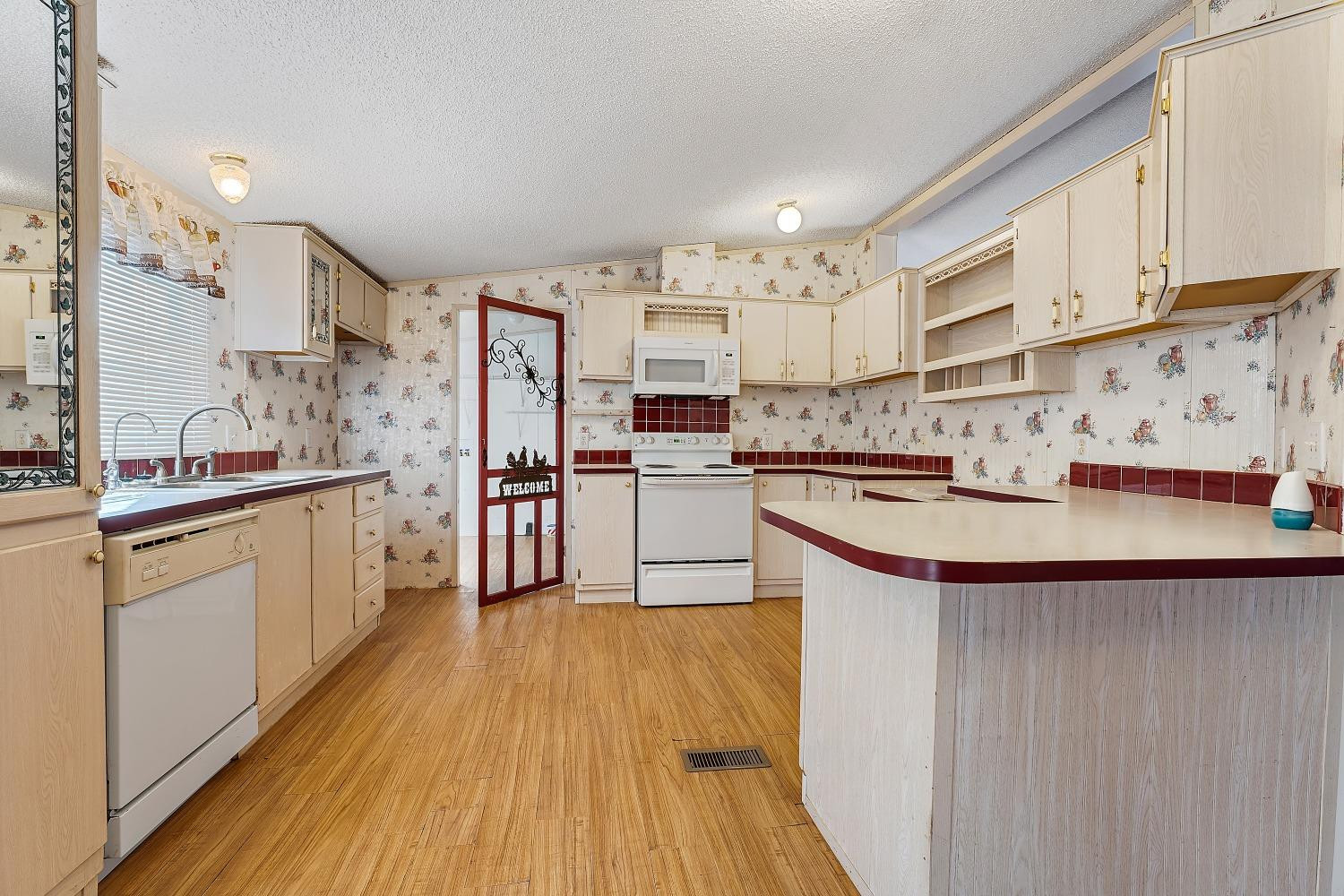 5501 County Road 1240 Lubbock, TX 79407 - Photo 7 of 22 a kitchen with stainless steel appliances a sink and a refrigerator