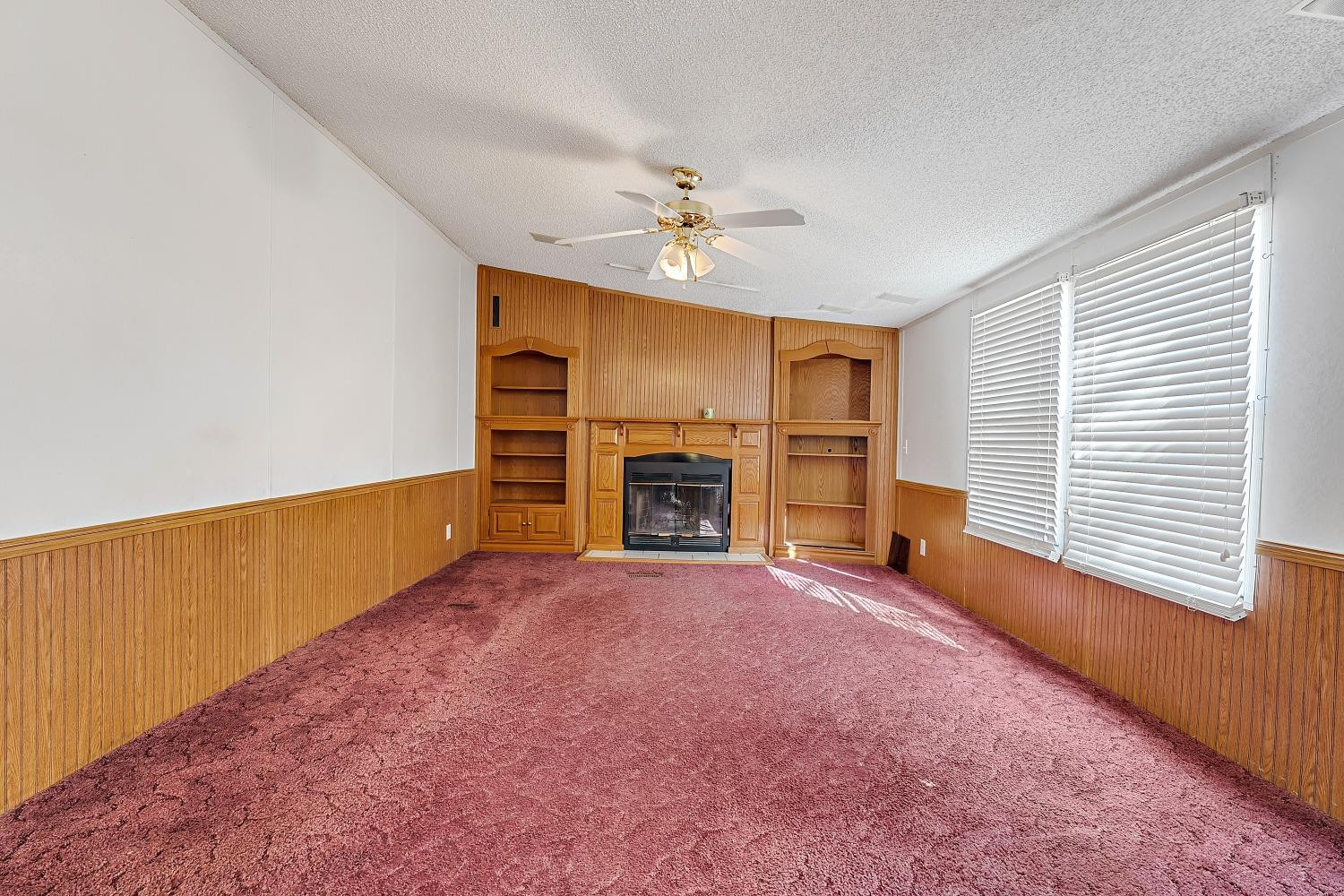 5501 County Road 1240 Lubbock, TX 79407 - Photo 9 of 22 wooden floor in an empty room with a fireplace