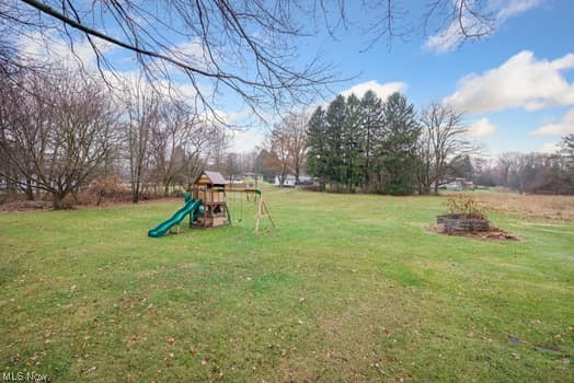 4618 South Arlington Road Uniontown, OH 44685 - Photo 20 of 31 View of yard featuring a playground
