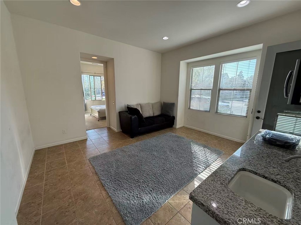 130 Follyhatch Irvine, CA 92618 - Photo 5 of 8 a living room with granite countertop furniture and a flat screen tv