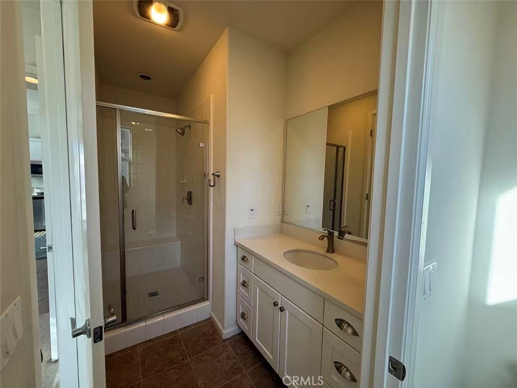 130 Follyhatch Irvine, CA 92618 - Photo 8 of 8 a bathroom with a granite countertop sink two mirror and shower