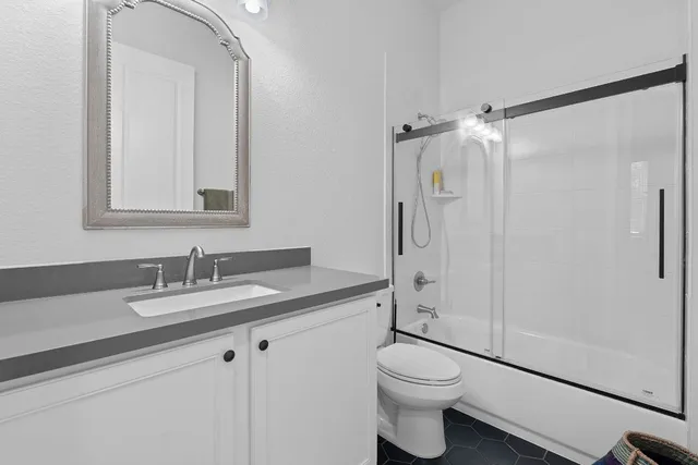 a bathroom with a toilet a sink and a mirror