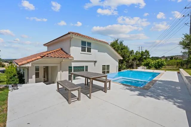 a front view of house with yard and trees