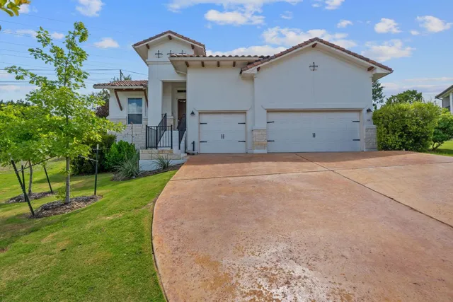 a view of a house with a yard and garage
