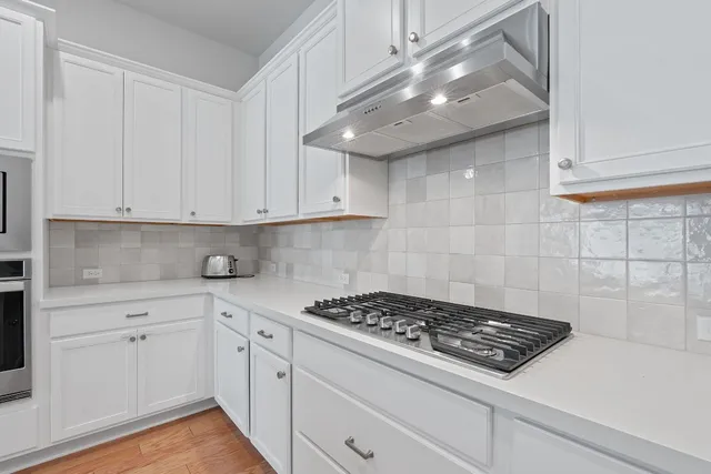a kitchen with a sink stainless steel appliances and cabinets