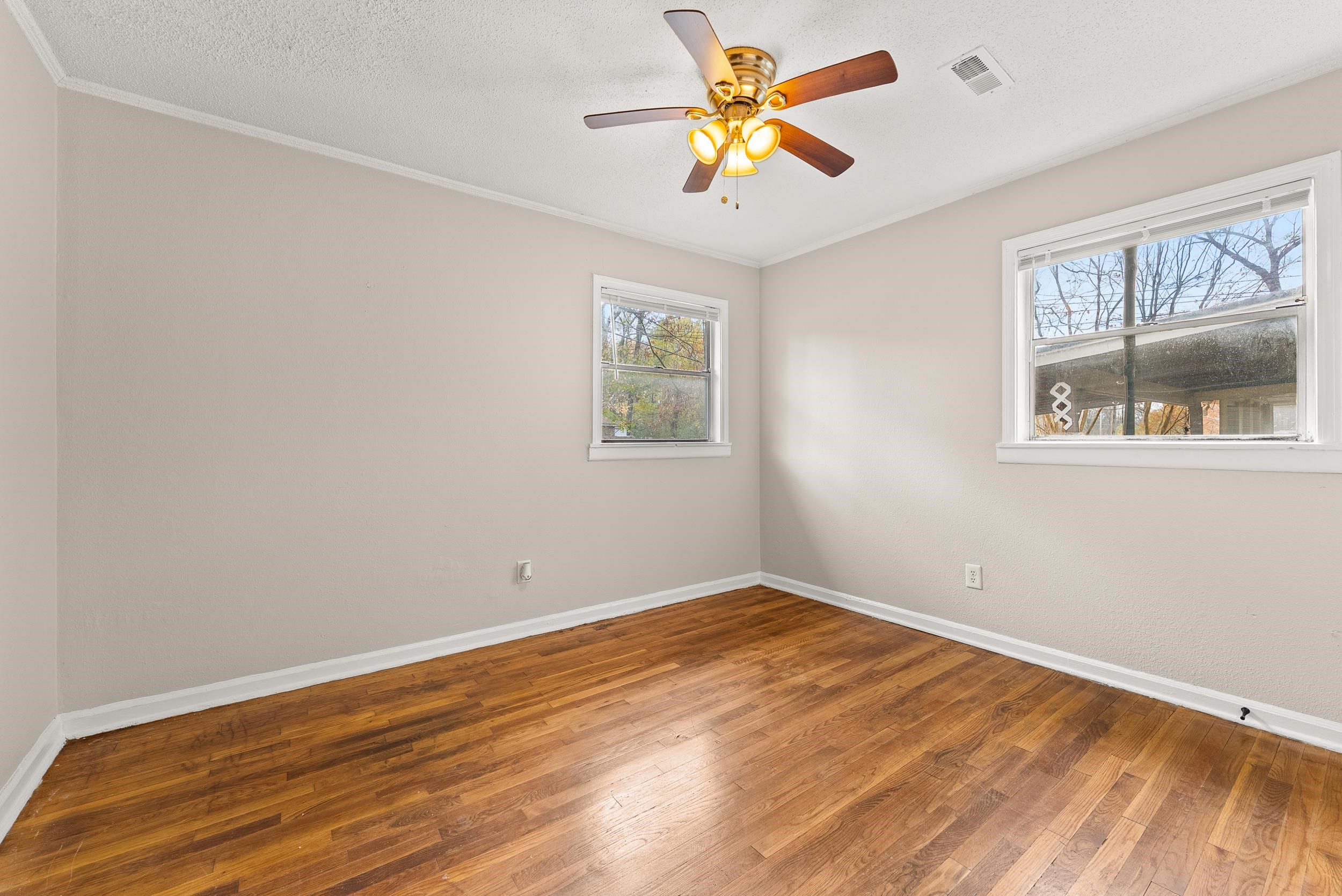 686 Delta Road Memphis, TN 38109 - Photo 17 of 24 an empty room with a window and a ceiling fan