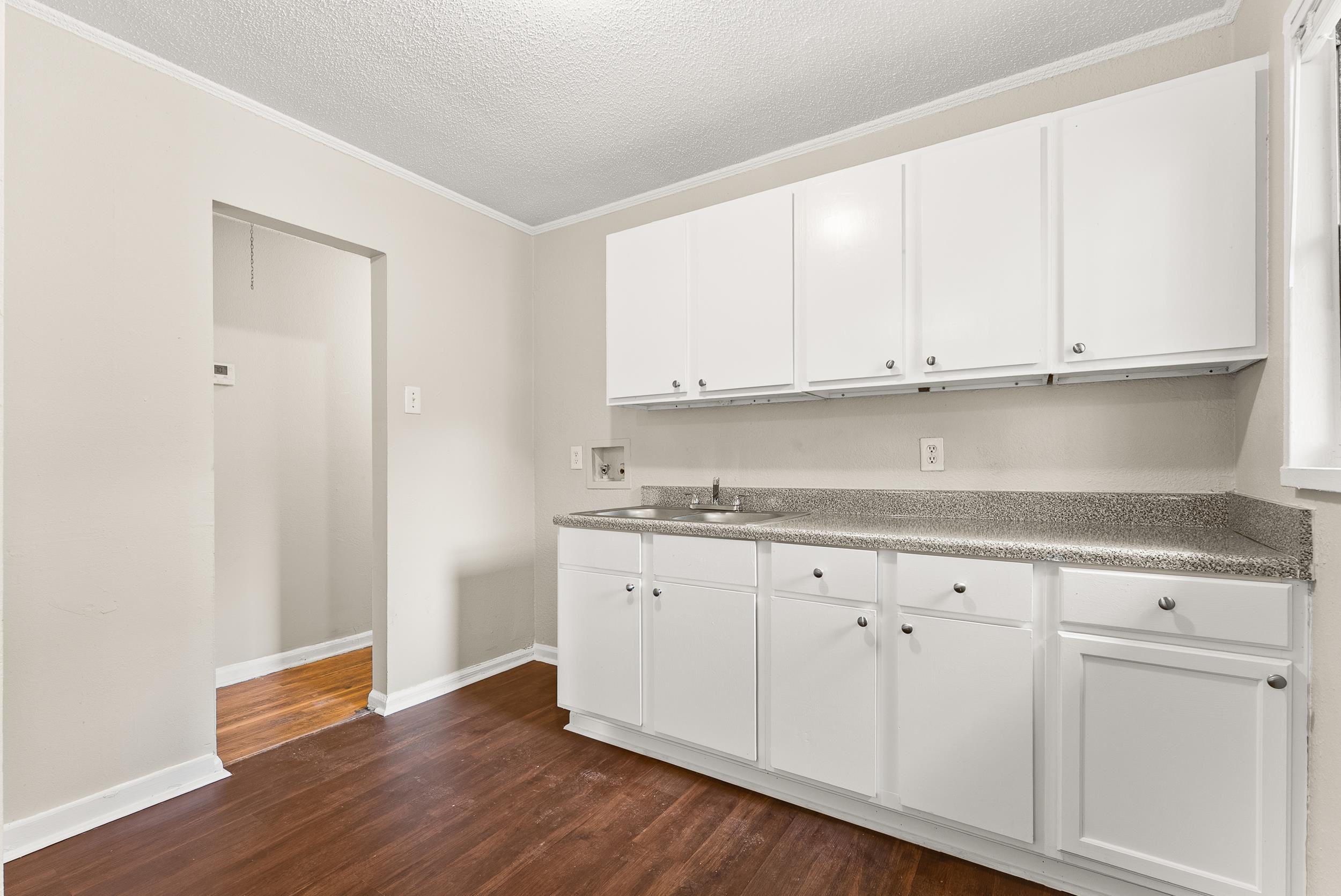 686 Delta Road Memphis, TN 38109 - Photo 10 of 24 a kitchen with granite countertop white cabinets and a sink