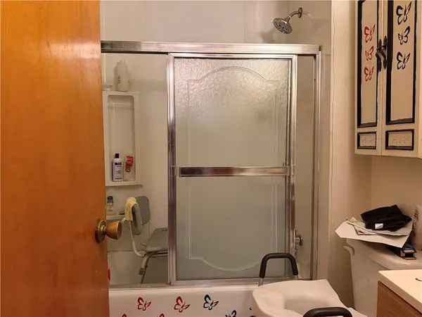 a bathroom with a sink toilet and shower
