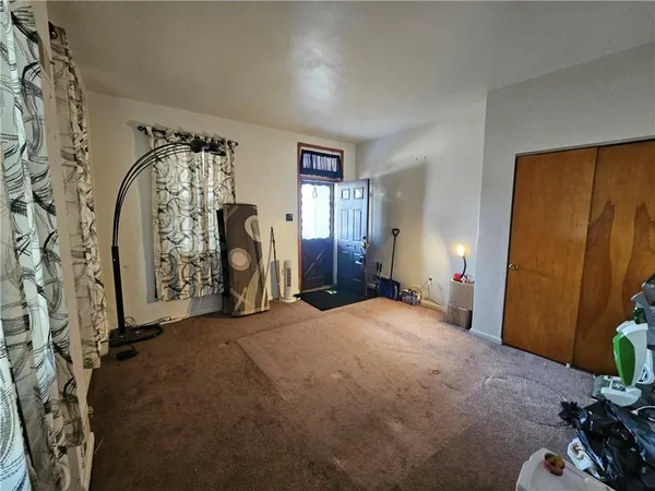 a view of a livingroom with furniture and a window