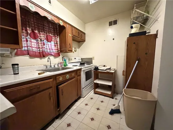 a kitchen with a sink appliances and cabinets