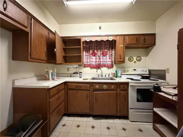 a kitchen with a sink cabinets and stainless steel appliances